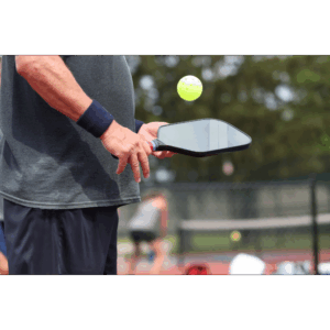 a man holding a pickleball paddle