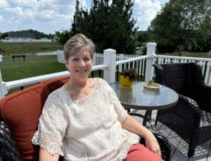 a woman sitting on a chair on a porch