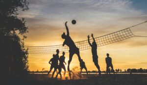 a group of people playing a game of volleyball