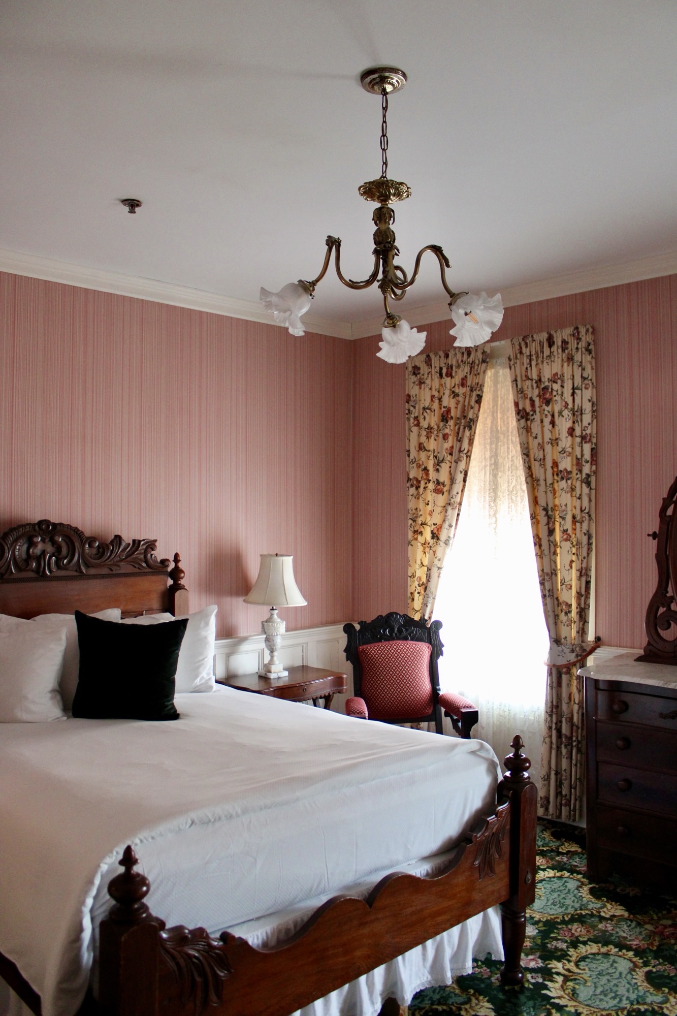room with red walls and white bed
