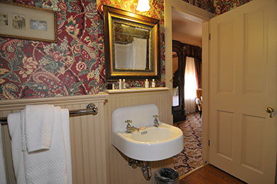 The Byron Room Bathroom Atlantic Hotel hotel room bathroom sink with gold mirror towel holder and picture on wall