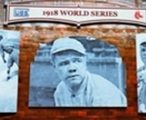 a brick wall with three pictures of baseball players on it