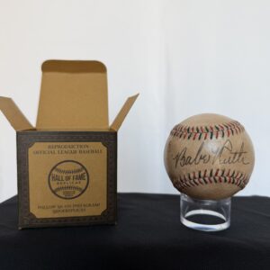 a baseball sitting on top of a table next to a box