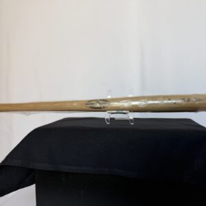 a baseball bat sitting on top of a black hat