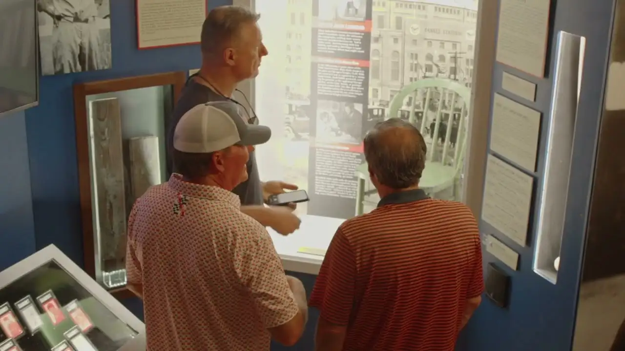 a group of men standing around a display in a museum