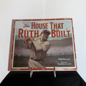 a baseball book with a picture of a man holding a bat