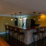 kitchen with wrap around countertop and barstools
