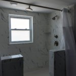 large walk in shower with multiple shower heads