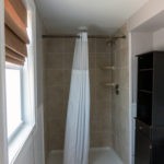 bathroom with toilet, and walk-in shower