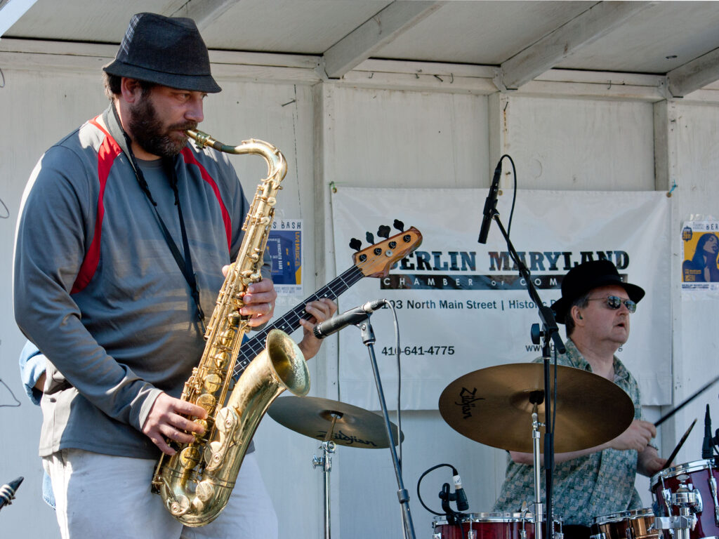a man playing a saxophone on a stage