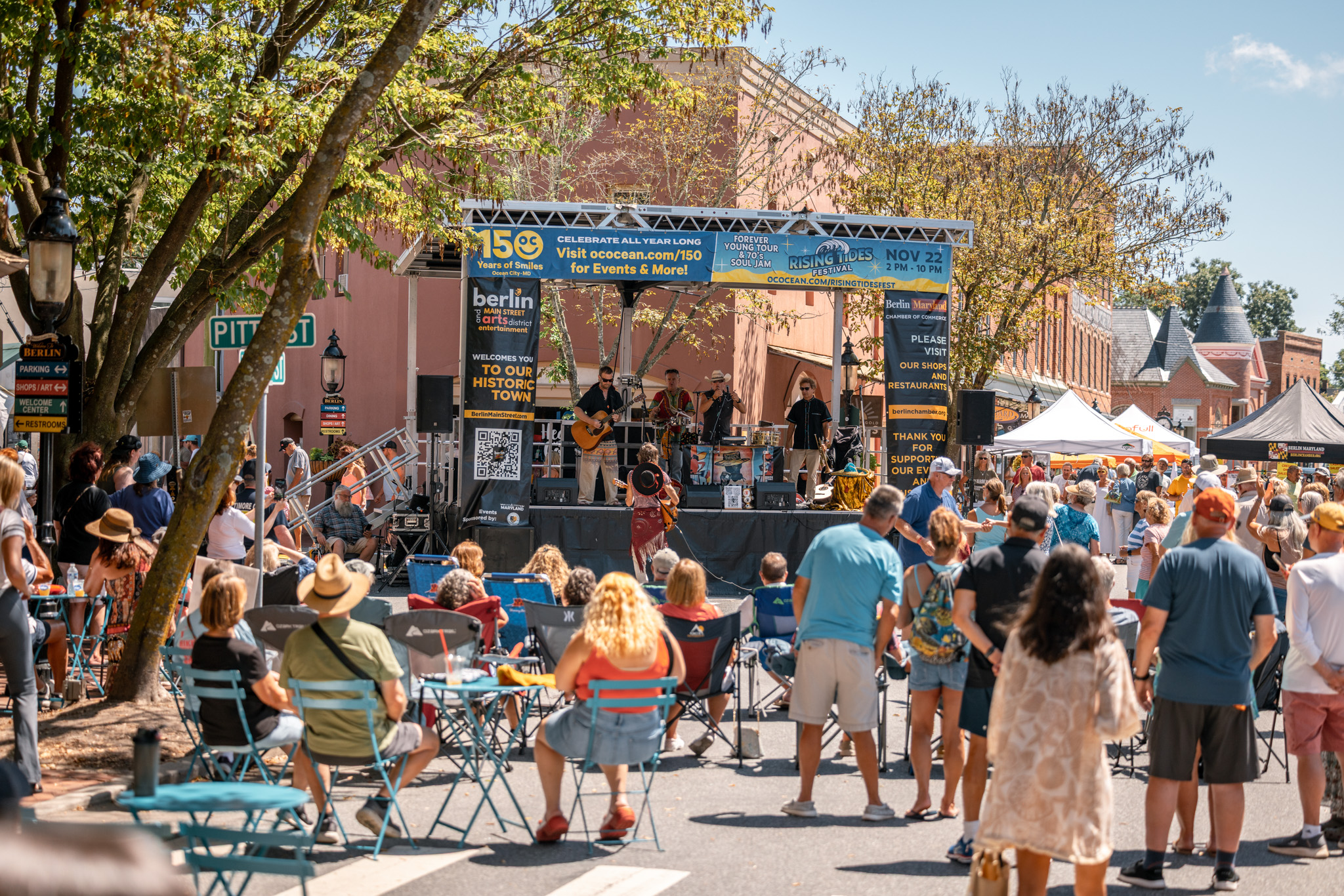 a crowd of people standing around a stage