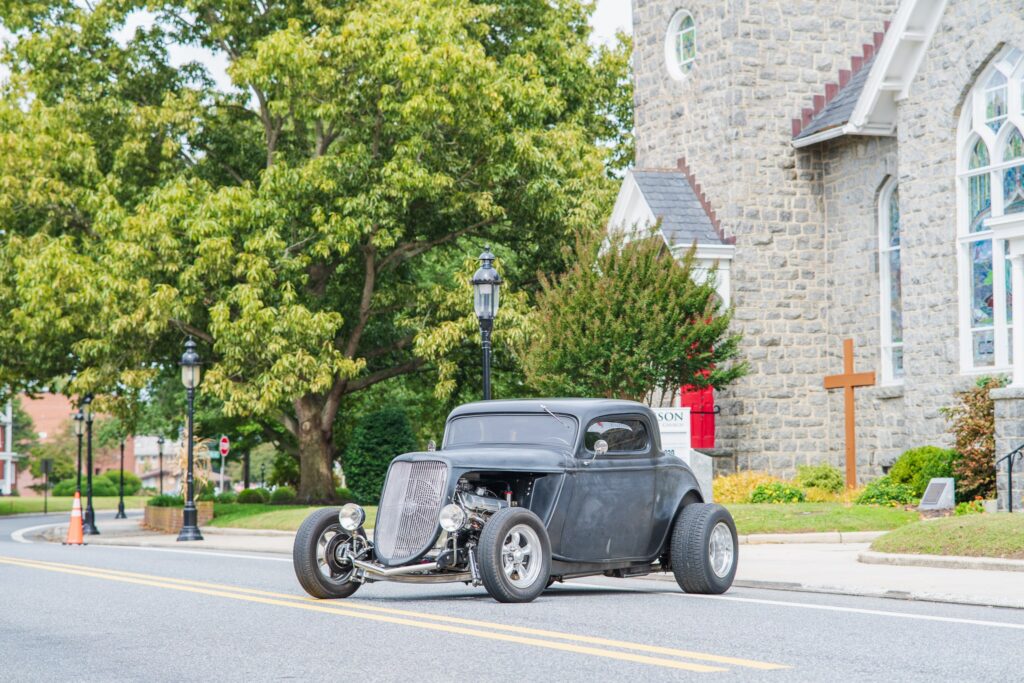 an old car parked on the side of the road