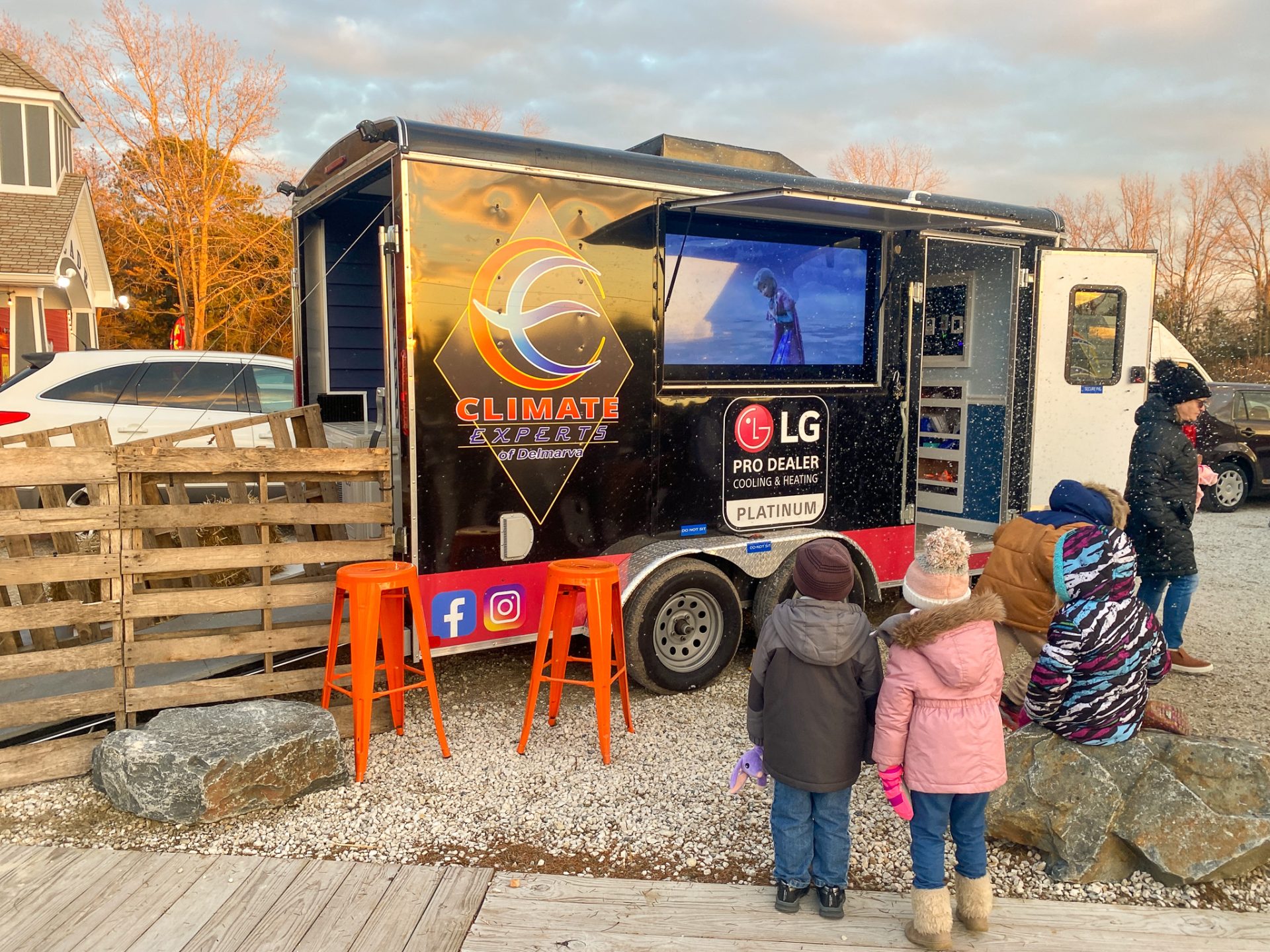 a group of people standing in front of a food truck