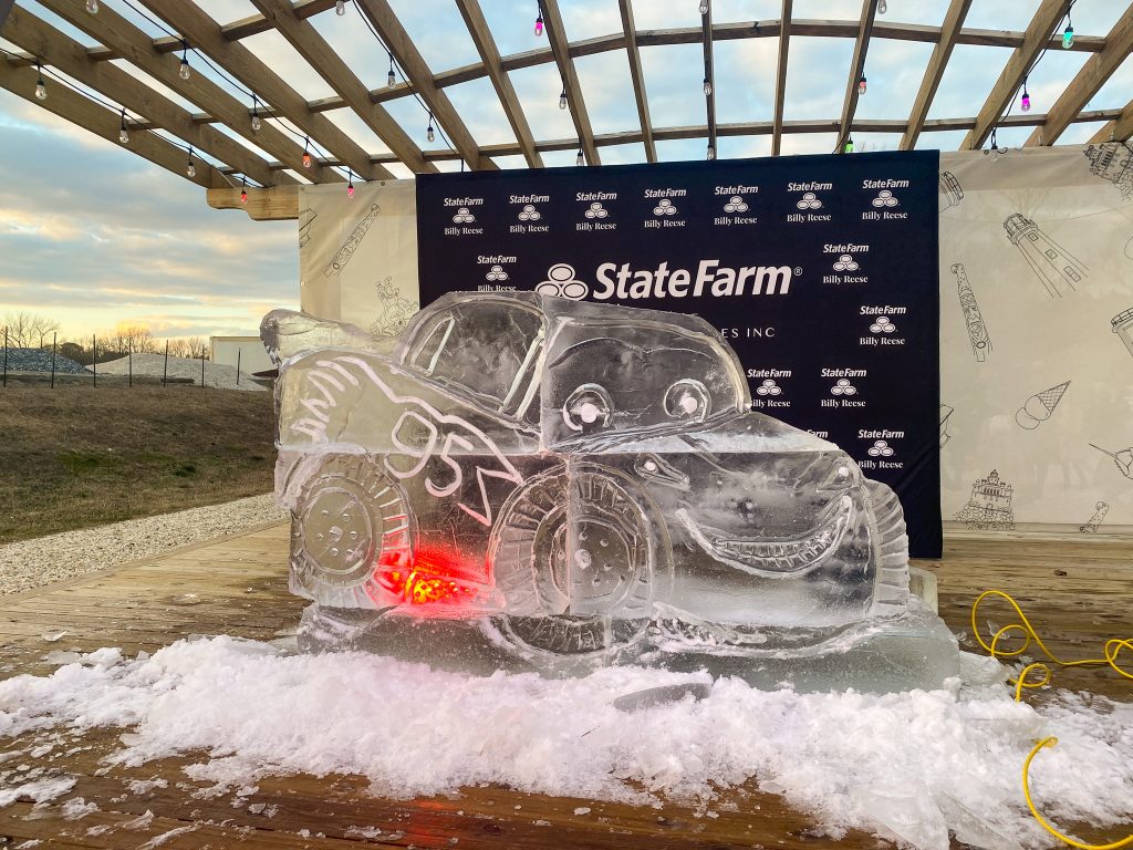 an ice sculpture of a car on top of a pile of snow