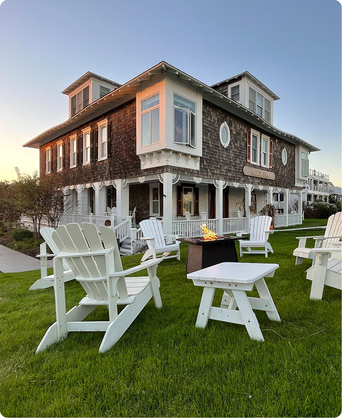 a group of lawn chairs sitting on top of a lush green field