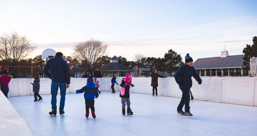 a group of people skating on an ice rink