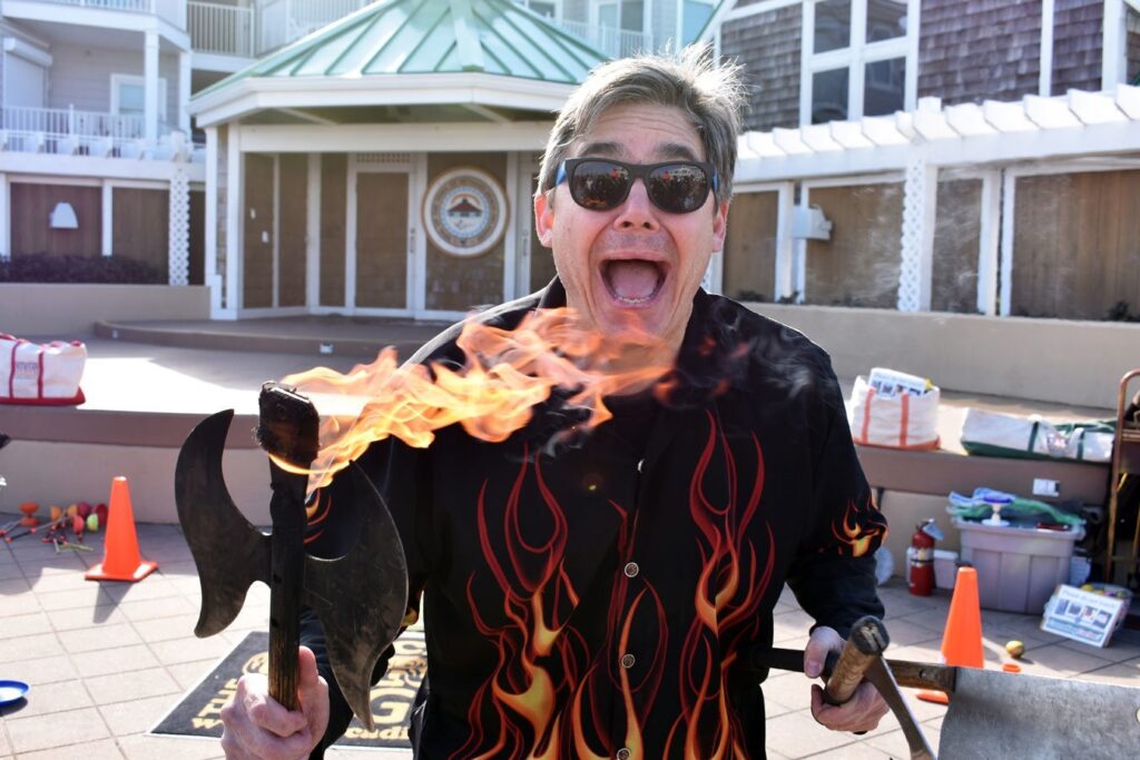a man holding a flaming fish in his hands