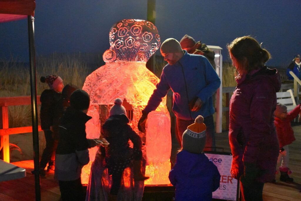 a group of people standing around a large ice sculpture