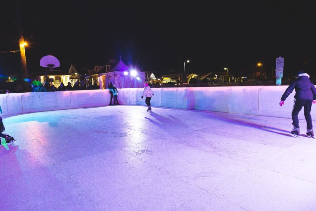 a group of people skating on an ice rink