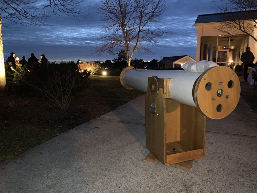 a large telescope sitting on top of a sidewalk
