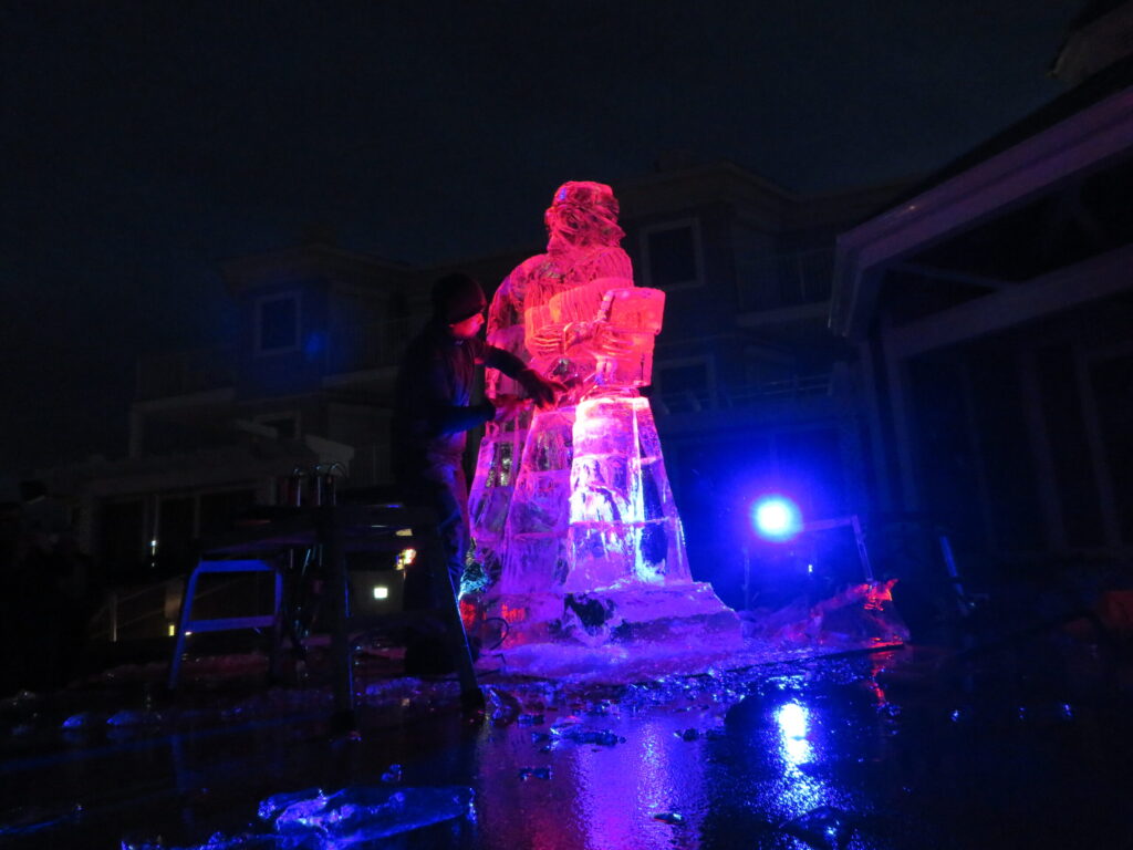 a man standing next to a large ice sculpture