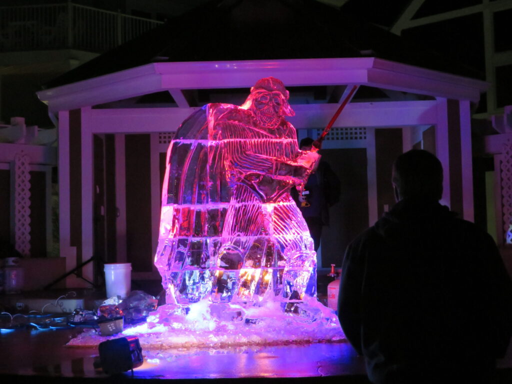 a man standing in front of a giant ice sculpture