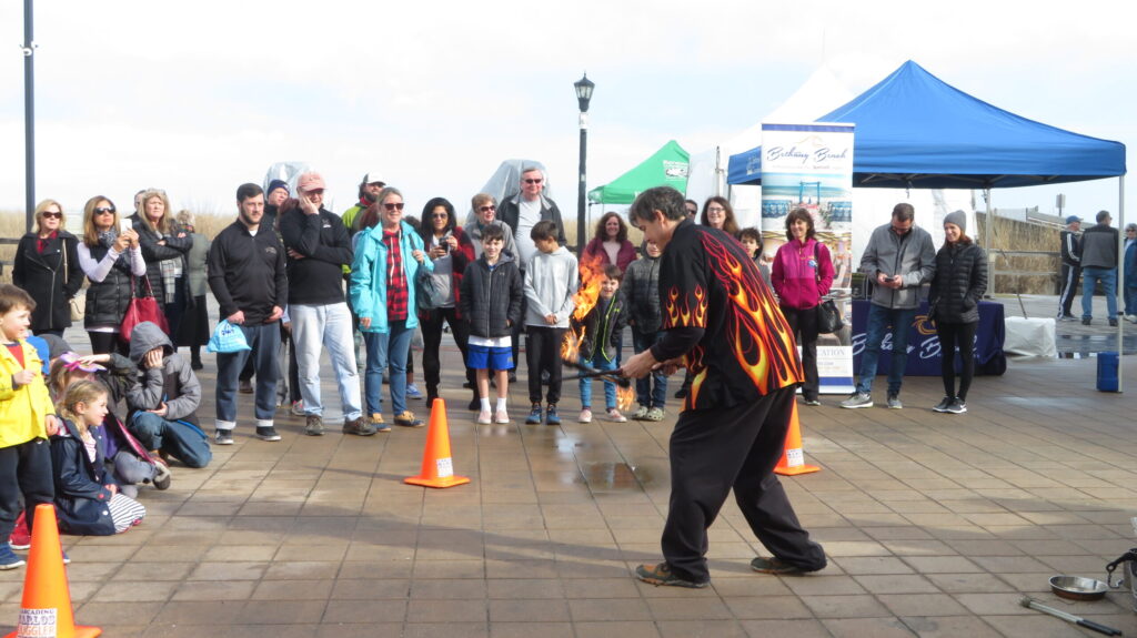 a group of people standing on a sidewalk next to orange cones