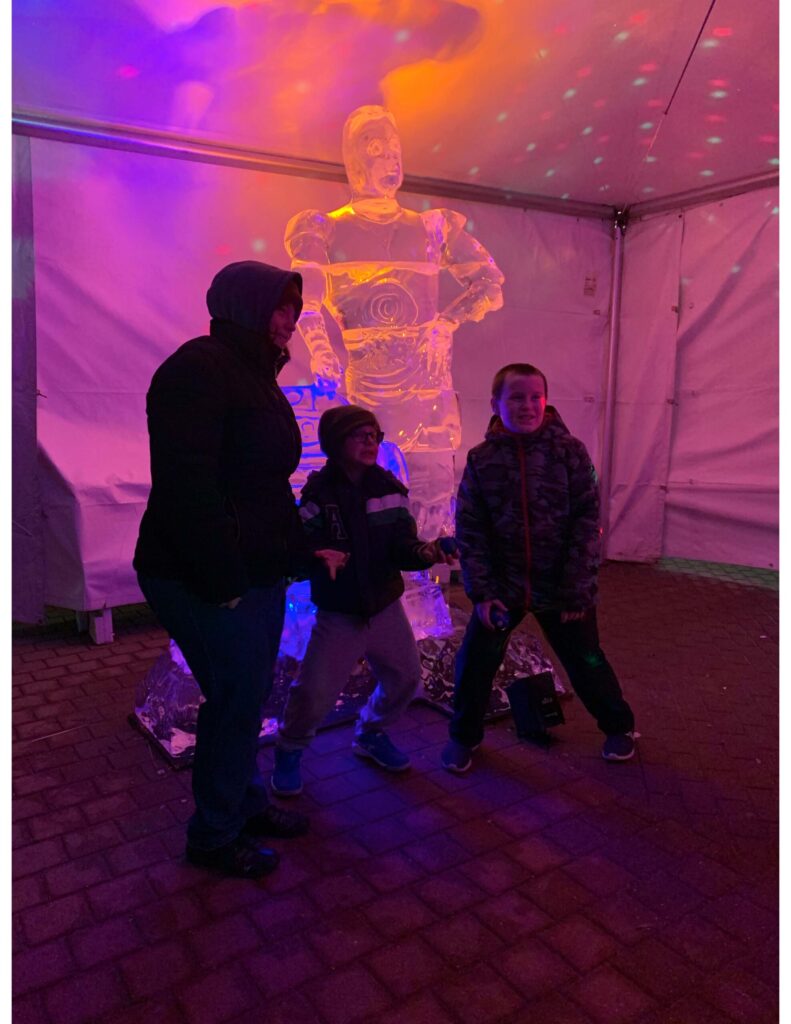 a group of people standing in front of a statue