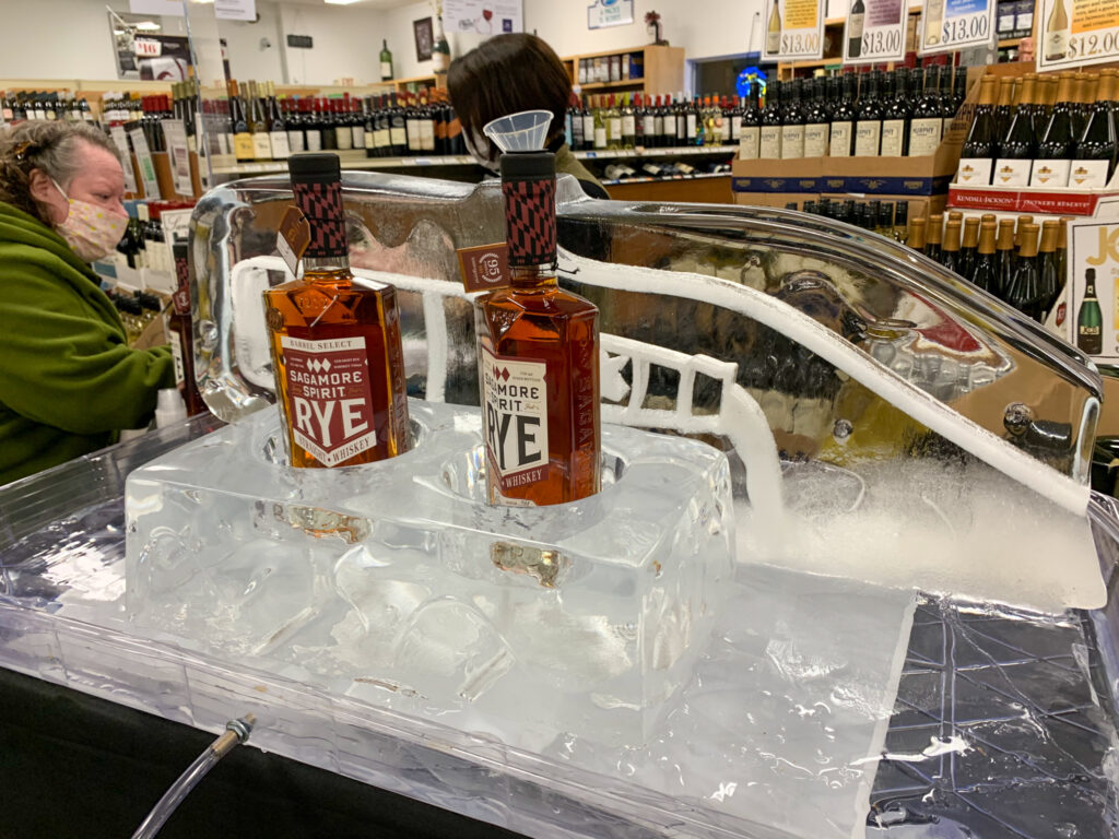 two bottles of booze sitting on top of an ice block