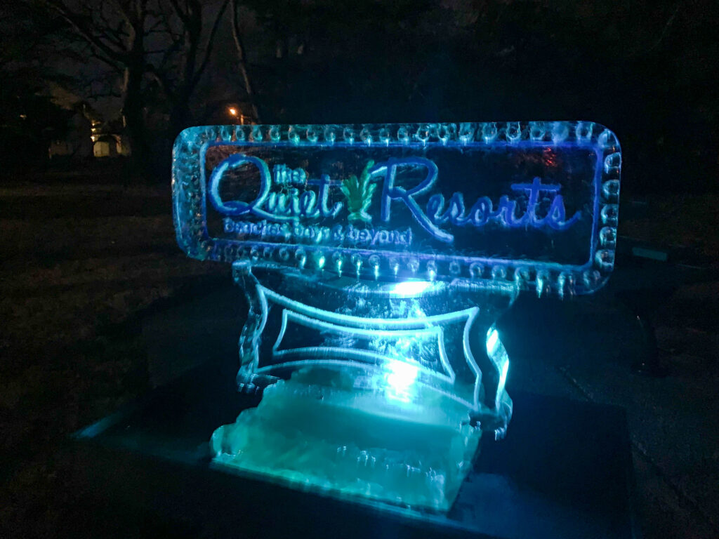 a lighted sign in a park at night