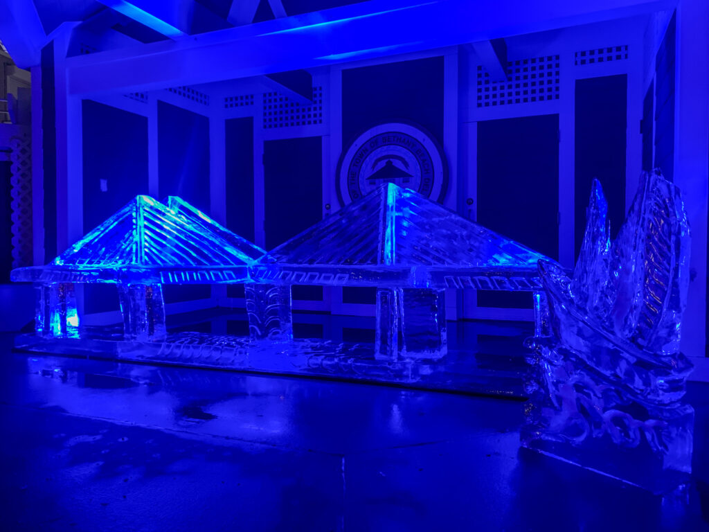 a blue lit room with a large window