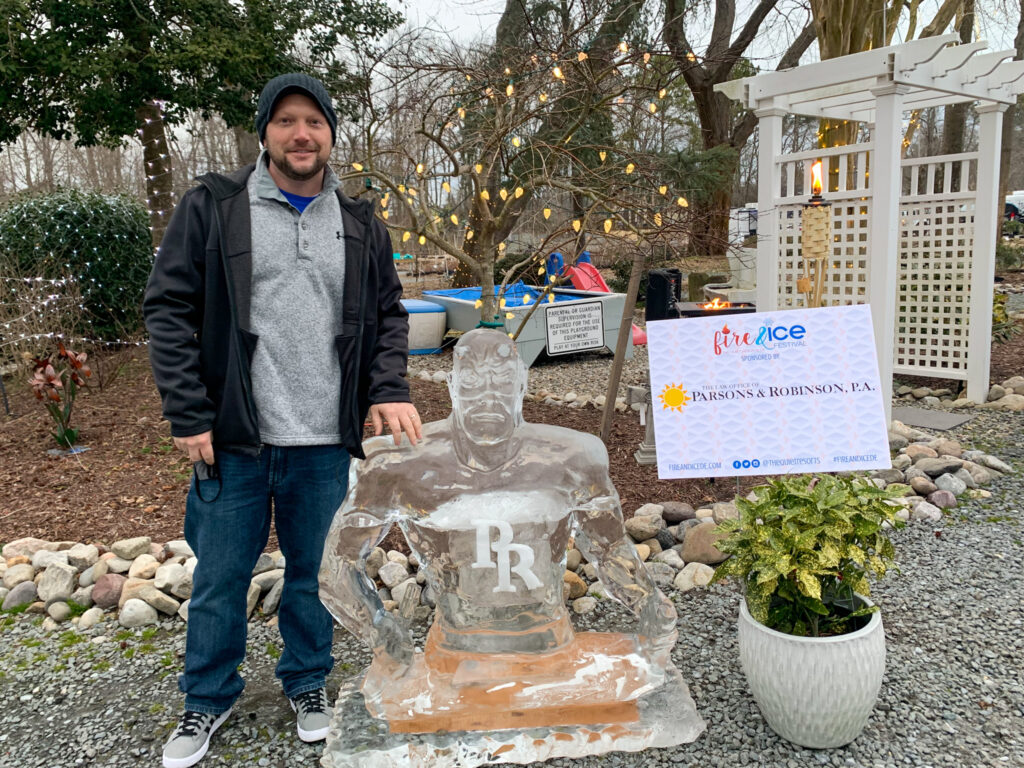 a man standing next to a glass bottle