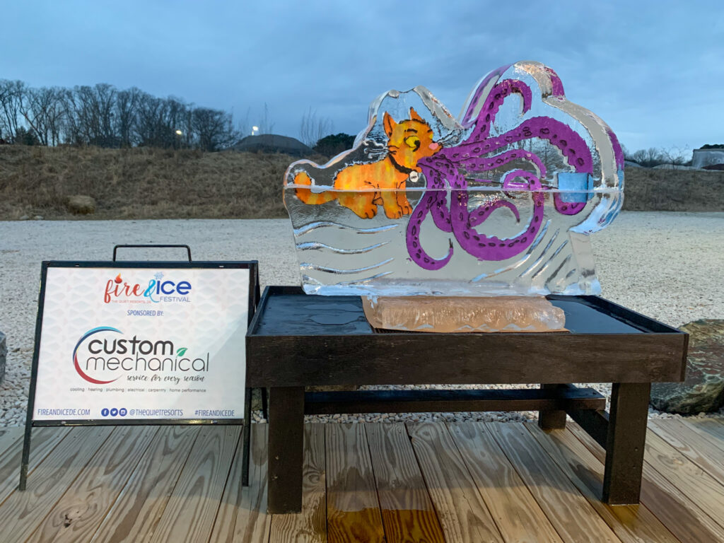 a glass sculpture of an octopus on a wooden table