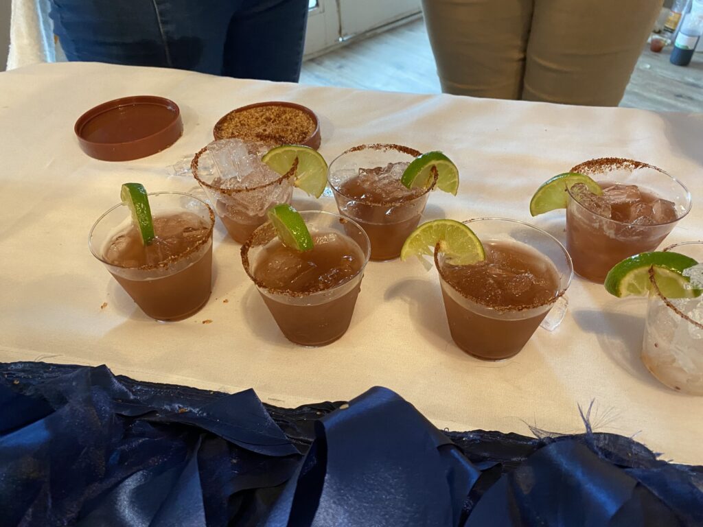 a table topped with cups filled with different types of drinks