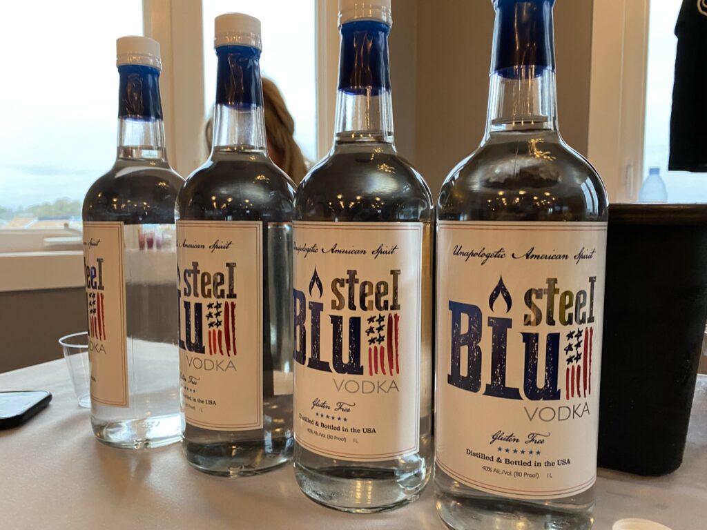 three bottles of blue mountain vodka on a table
