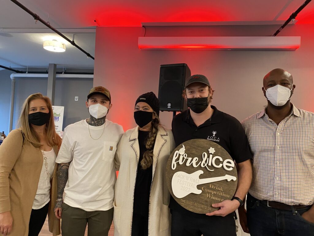 a group of people wearing face masks posing for a picture
