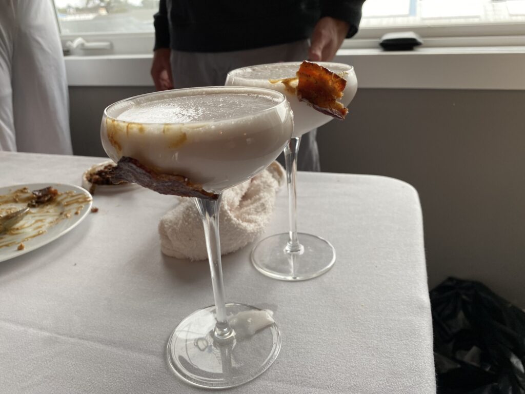 a person standing next to a table with a plate of food on it