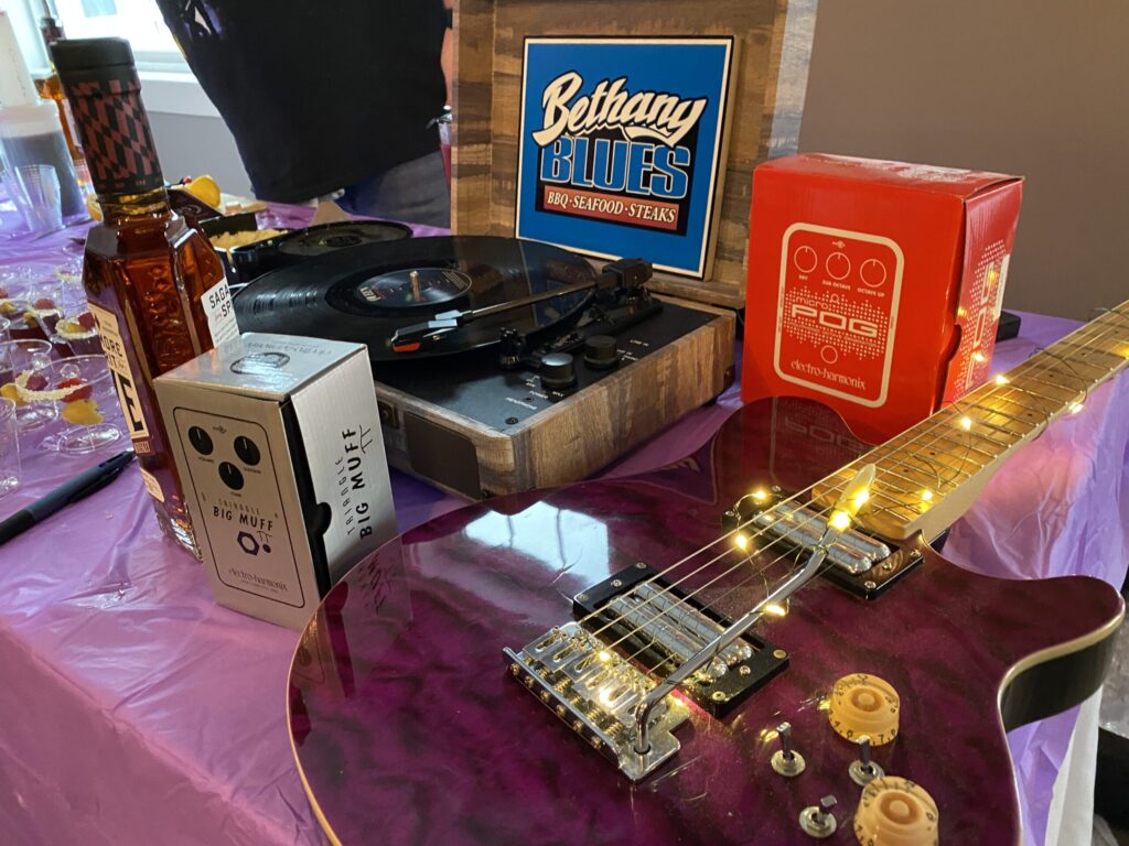 a purple guitar sitting on top of a purple table