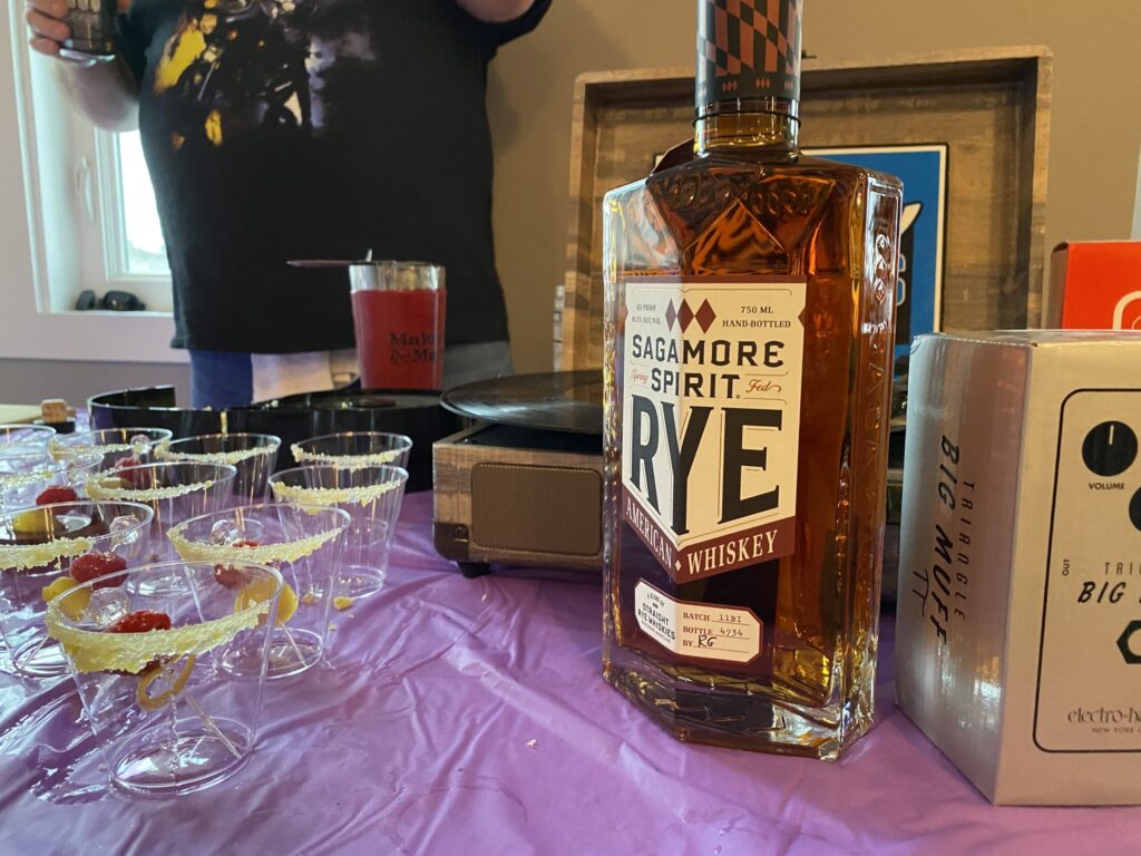 a table topped with glasses and bottles of liquor