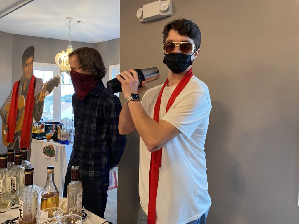 a man wearing a face mask and drinking from a can
