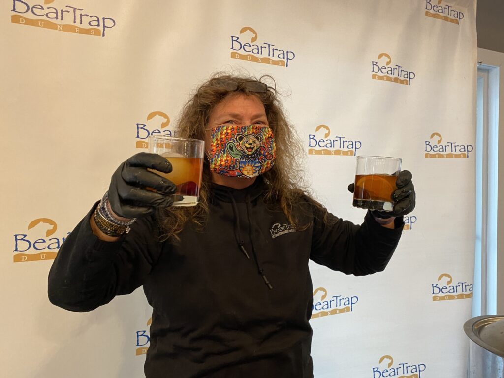 a man holding a glass of beer in front of his face
