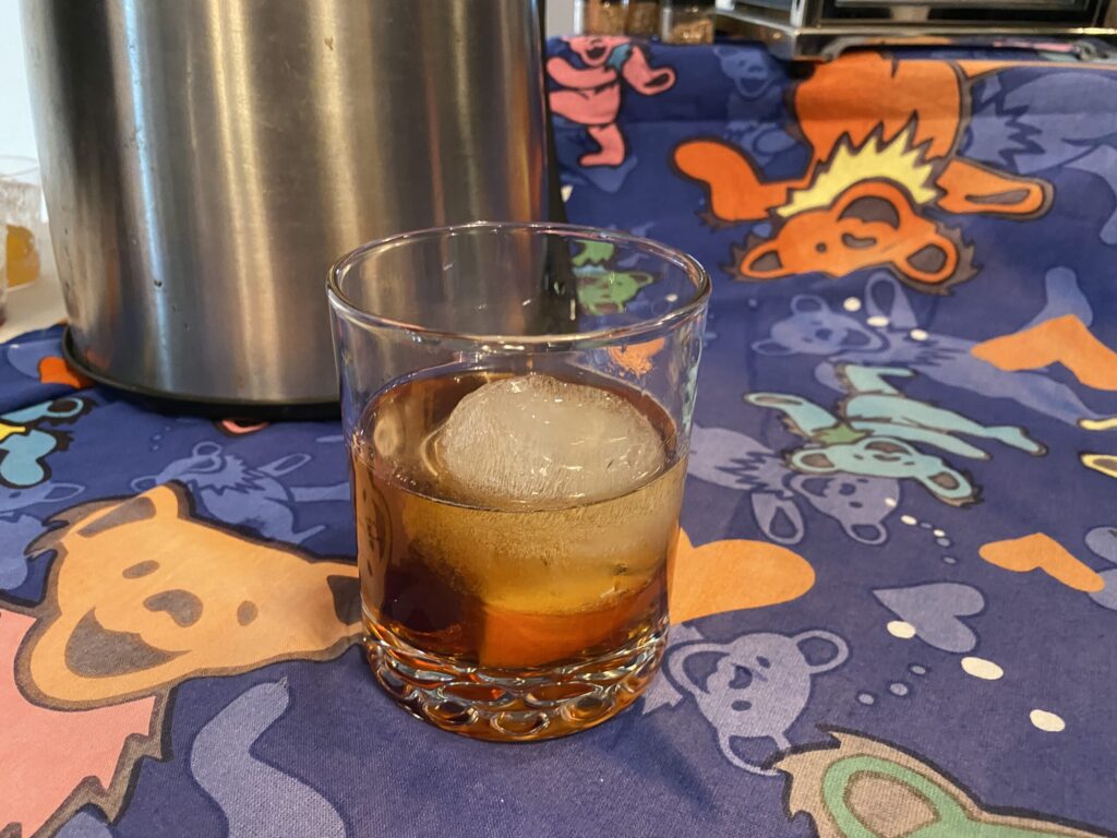a glass filled with ice sitting on top of a table