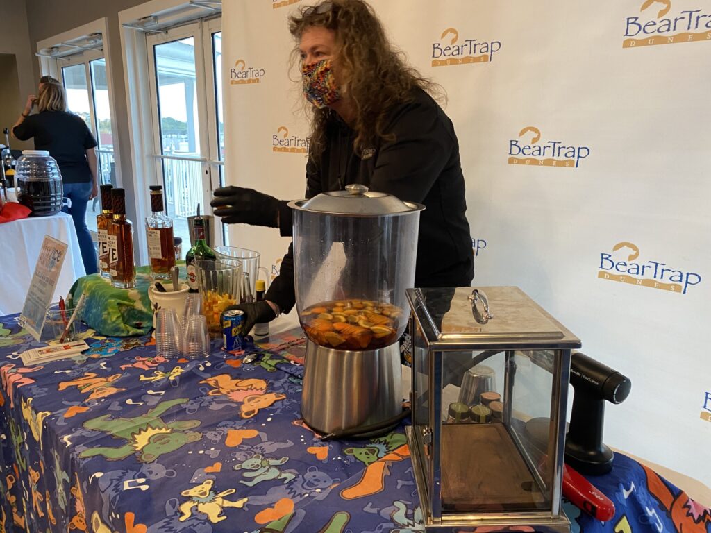 a man standing next to a table with food on it