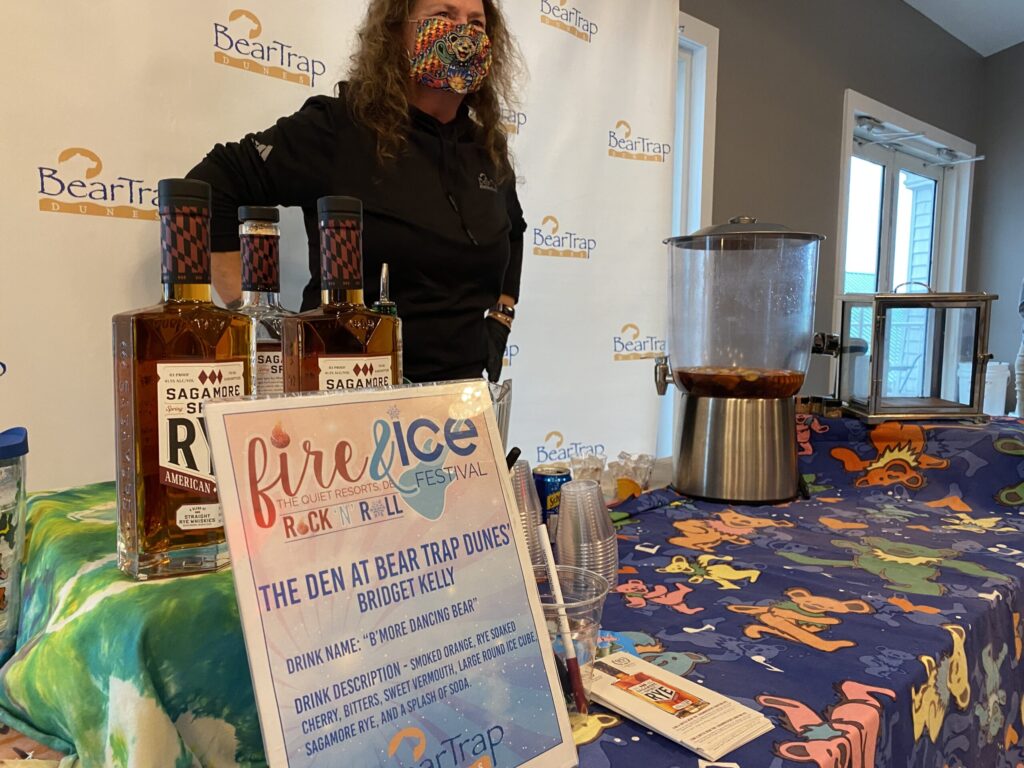 a woman standing behind a table with a sign on it