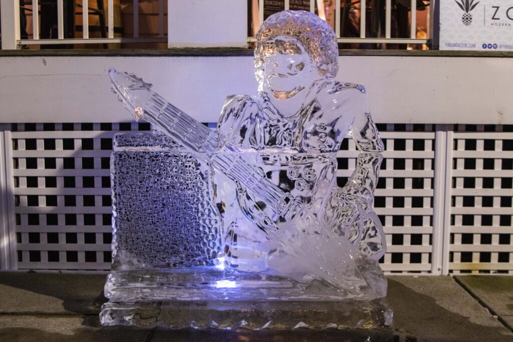a glass sculpture of a man playing a guitar