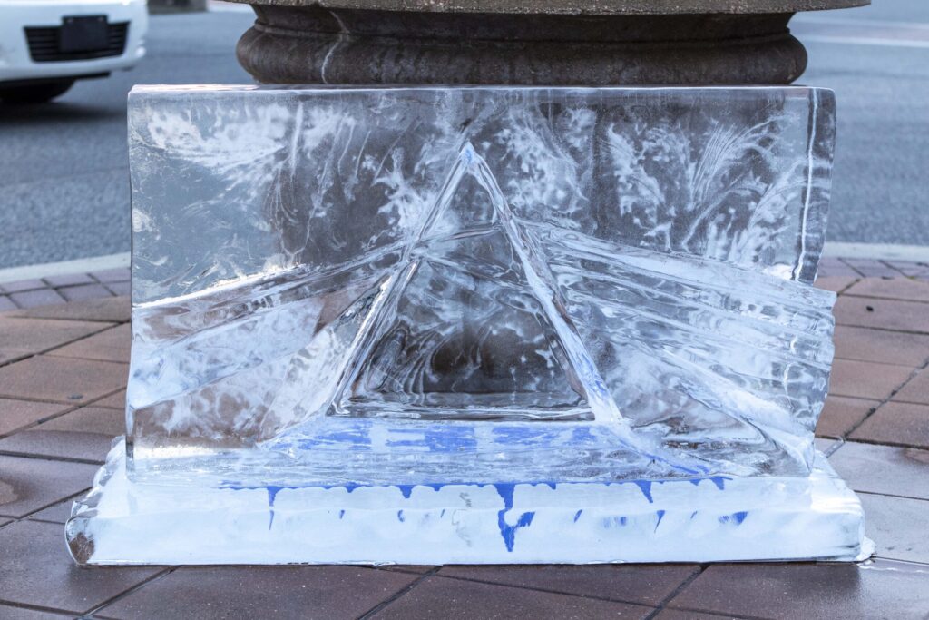 a sculpture made of ice on a sidewalk