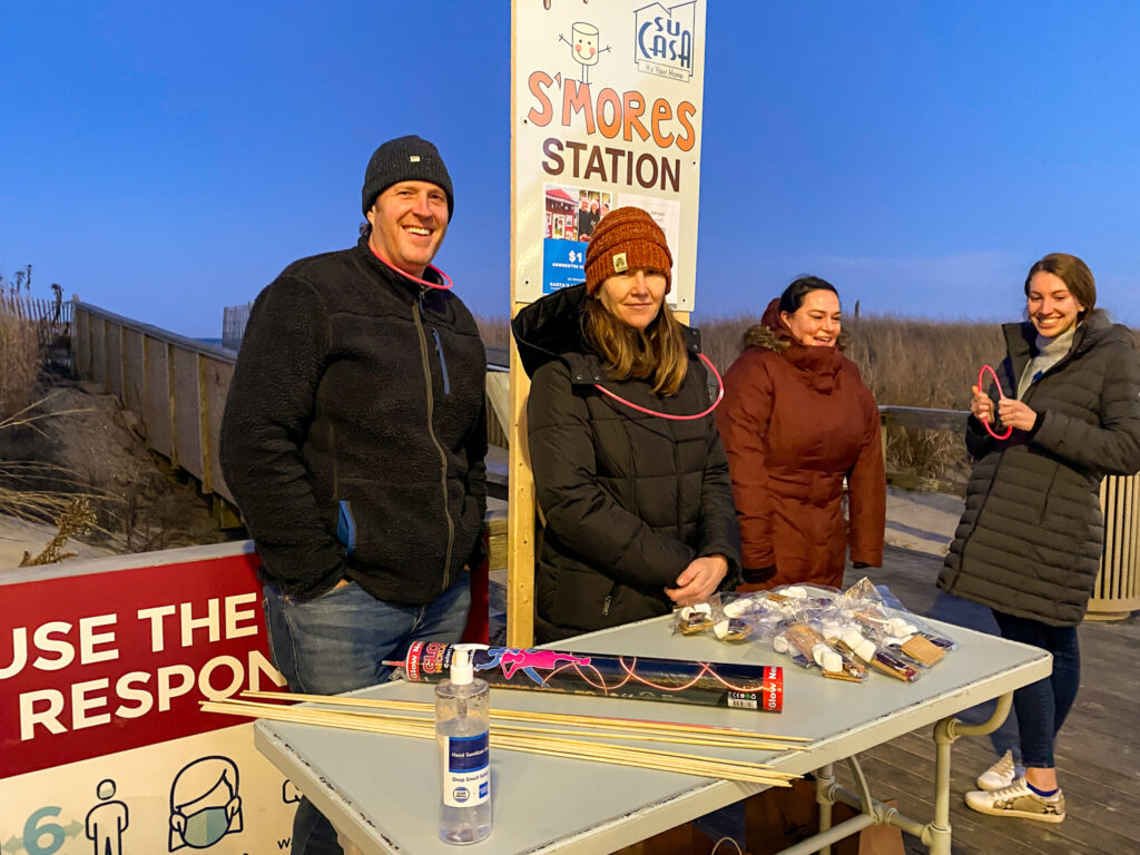 a group of people standing around a table