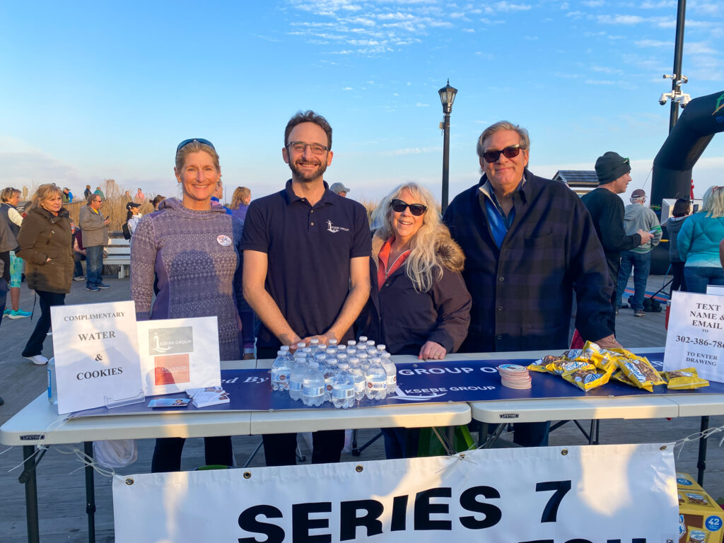 a group of people standing behind a table