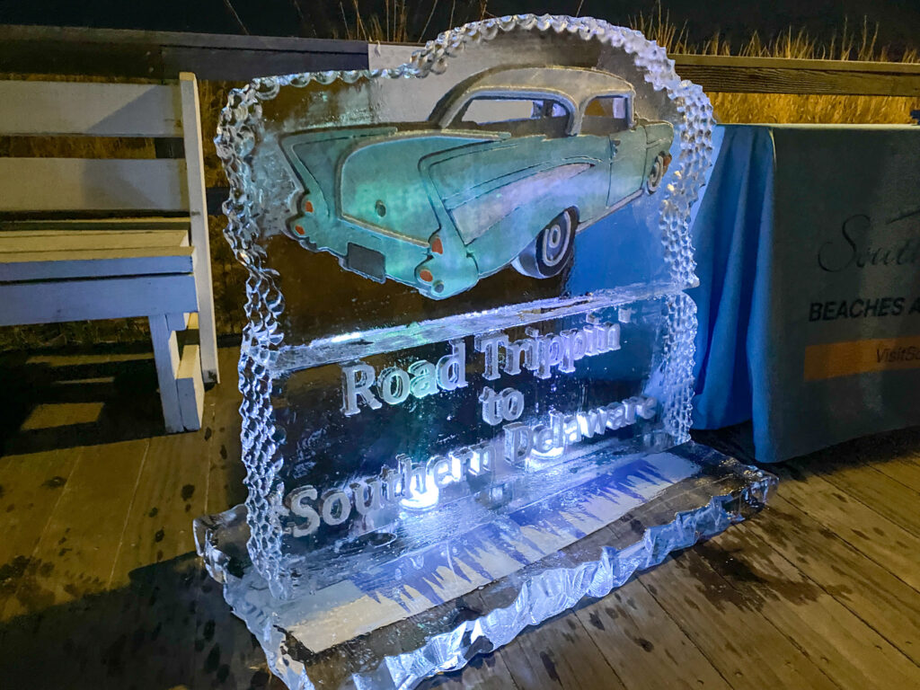 an ice sculpture of a car on a wooden floor