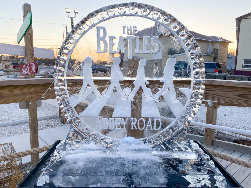 an ice sculpture of the beatles on a wooden deck